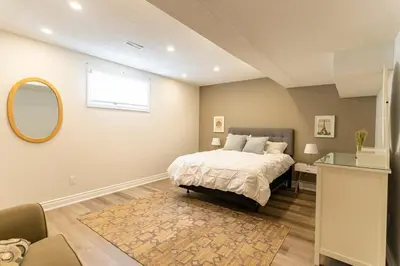 a bedroom with a bed and a mirror at Luxurious and Spacious Apartment with 2 bedrooms and 2 Baths in Mississauga