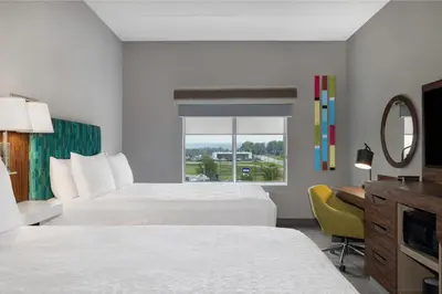 a hotel room with two beds and a window at Hampton Inn Midland, On in Midland