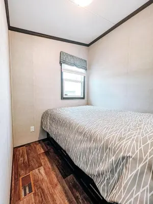 a bedroom with a bed in a room with a window at Bellmere Winds Resort in Keene