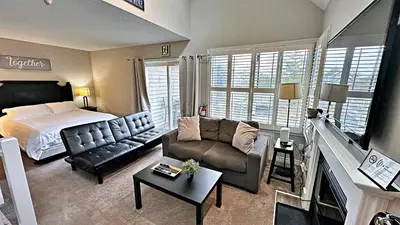 a living room with a bed and a couch at Freshly Upgraded Cozy Loft @ North Creek Resort in Blue Mountains