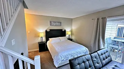 a bedroom with a bed with a sign above it at Freshly Upgraded Cozy Loft @ North Creek Resort in Blue Mountains