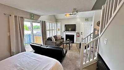 a bedroom with a bed and a living room at Freshly Upgraded Cozy Loft @ North Creek Resort in Blue Mountains