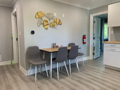 a dining room with a table and four chairs at Ambiance by the Falls Cozy Suite in Niagara Falls