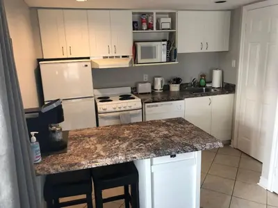 a kitchen with white appliances and a marble counter top at Freshly Upgraded Cozy Studio @ North Creek Resort in Blue Mountains