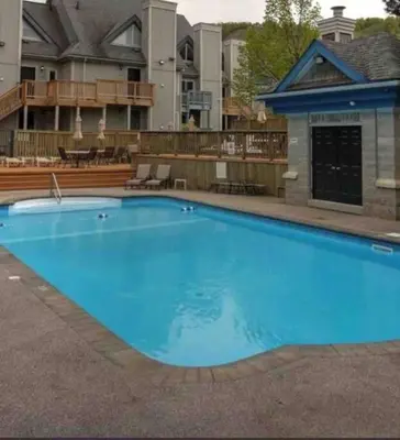 a large blue swimming pool in front of a building at Freshly Upgraded Cozy Studio @ North Creek Resort in Blue Mountains