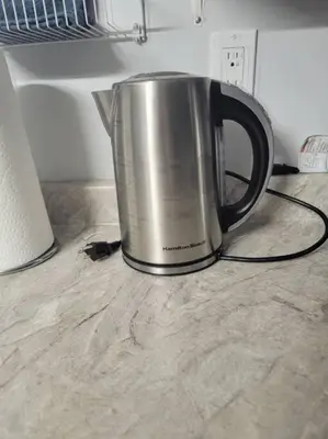 a silver coffee pot sitting on a kitchen counter at Staycation Studio Apartment, Private kitchen , Washroom, Micro Gym & Free Onsite Parking in London