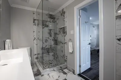 a bathroom with a shower and a sink at Niagara Luxury Suites in Niagara Falls