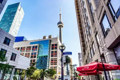 a view of the cn tower from a street with buildings at RHD Luxury Condos-Downtown, CN Tower, Metro Toronto Convention Centre, Rogers Centre, Free Parking in Toronto