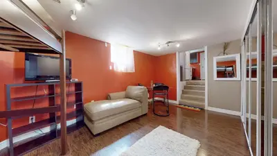 a living room with a couch and a television at ZARA's UNIQUE APARTMENT in Mississauga