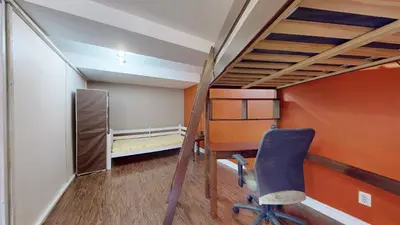 a room with a desk and a bunk bed and a chair at ZARA's UNIQUE APARTMENT in Mississauga