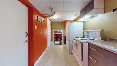 a kitchen with an orange and white stove top oven at ZARA's UNIQUE APARTMENT in Mississauga