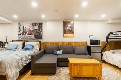 a living room with a couch and a bed at BIG Oasis Studio near Airport YYZ in Toronto