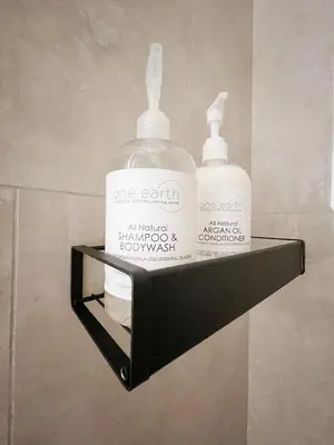 two bottles of soap on a shelf in a bathroom at Inn On King Bed & Breakfast in Niagara on the Lake