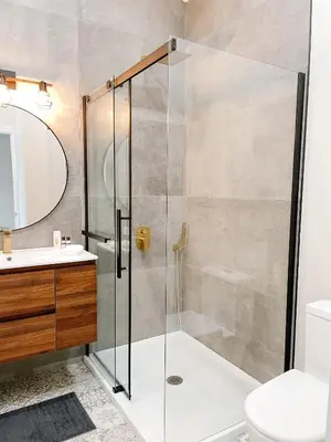 a bathroom with a shower and a toilet and a sink at Inn On King Bed & Breakfast in Niagara on the Lake