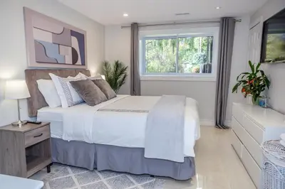 a bedroom with a white bed and a window at Nature Oasis BarMar 2BR Suite in Dundas close to Webster Falls in Dundas