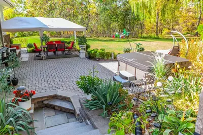 a patio with an umbrella and a table and chairs at Nature Oasis BarMar 2BR Suite in Dundas close to Webster Falls in Dundas