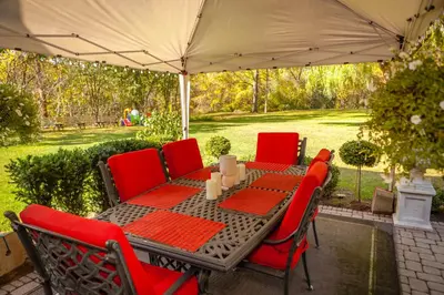 a patio table and chairs under an umbrella at Nature Oasis BarMar 2BR Suite in Dundas close to Webster Falls in Dundas