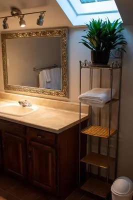 a bathroom with a sink and a mirror at Upper Canada Coach House in Niagara on the Lake