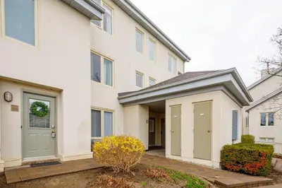 a white house with a green door at Steps to Blue Mtn Condo wt Elegant Style 213 Sierra Lane in Blue Mountains