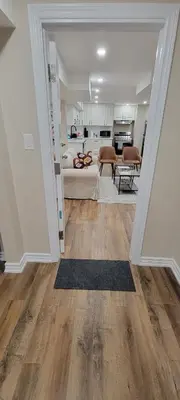 a living room with a couch and a kitchen at Guest Suite in Whitby in Whitby