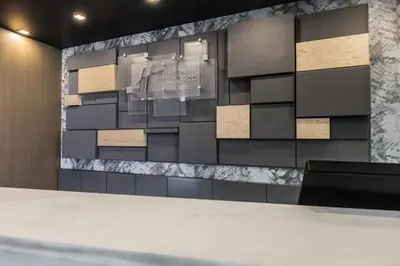 a room with a wall with a display with a table at Holiday Inn Express & Suites Toronto Airport South by IHG in Toronto