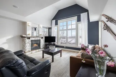 a living room with a couch and a fireplace at Rivergrass Home with Mountain and Golf Course Views in Blue Mountains