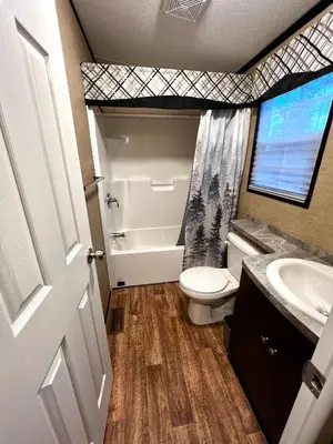 a bathroom with a toilet and a sink at Vine Ridge Resort - Cottages in Niagara on the Lake