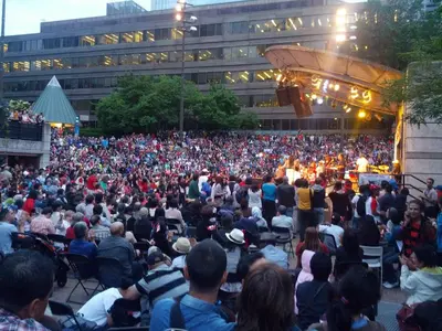 a large crowd of people sitting in chairs watching a concert at Modern House in Toronto in Toronto