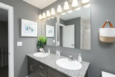 a bathroom with two sinks and a large mirror at Exceptional 3 BDRM Townhome - 4 Seasons Rental in Collingwood