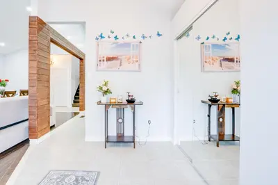 a hallway with two tables and a mirror at Furnished Family Home near Toronto - Great Location Game Room - Backyard - Parking & Self Checkin in Pickering