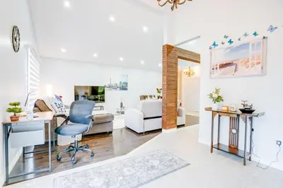 a living room with a desk and a chair at Furnished Family Home near Toronto - Great Location Game Room - Backyard - Parking & Self Checkin in Pickering