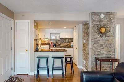a kitchen with two blue stools at a bar at Condo 204 at North Creek Resort in Blue Mountains
