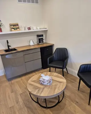 a room with a table and two chairs and a kitchen at Gabby's Place Downtown Core in Toronto