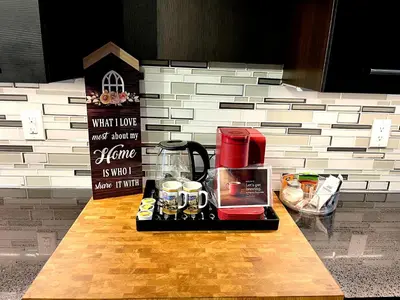 a kitchen counter with a coffee maker on a table at Stunning Rooms in Townhouse across the Beach in Toronto