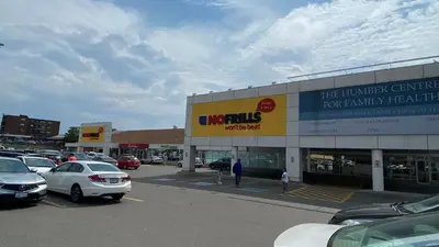 a car dealership with cars parked in a parking lot at Spectacular 3 BR 2 WR House - Close to Airport in Toronto