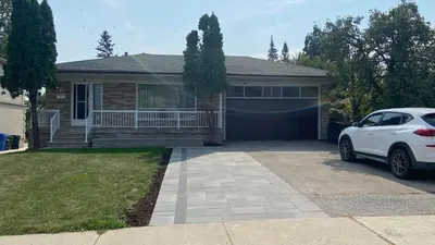 a white car parked in front of a house at Spectacular 3 BR 2 WR House - Close to Airport in Toronto