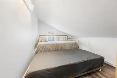 a bedroom with a bed in the corner of a room at Luxe Lodges on Lake Erie in Port Dover