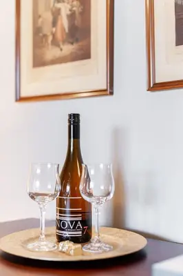 a bottle of wine and two glasses on a table at Lake Suite with Sunroom by Henry House Stays in Stratford