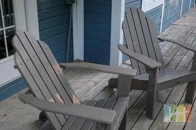 two wooden chairs sitting on the porch of a house at Horseshoe Retreat in Edgar