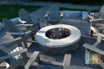 two chairs and a fire pit in a patio at Horseshoe Retreat in Edgar