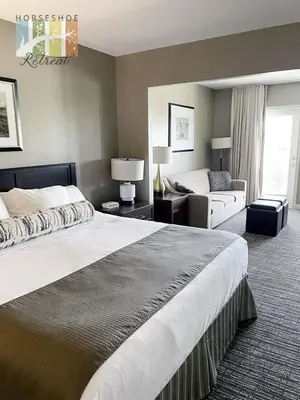 a hotel room with a large bed and a couch at Horseshoe Retreat in Edgar