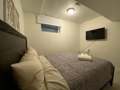 a bedroom with a bed and a flat screen tv at Yorkmills and Bayview !C Cozy & Stylish Private Bdr with Shared Bathroom in Toronto