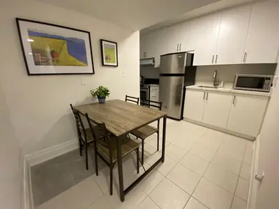 a kitchen with a wooden table and chairs in it at Yorkmills and Bayview !C Cozy & Stylish Private Bdr with Shared Bathroom in Toronto
