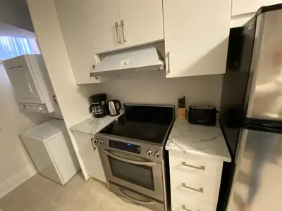 a small kitchen with a stove and a refrigerator at Yorkmills and Bayview !C Cozy & Stylish Private Bdr with Shared Bathroom in Toronto