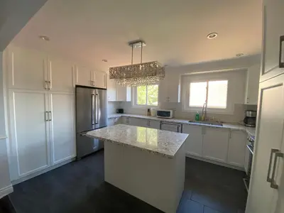 a kitchen with white cabinets and a granite counter top at Yonge and Finch Subway !O Cozy & Modern Private Bdr with Private Half Bathroom in Toronto