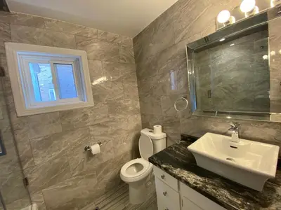 a bathroom with a sink and a toilet and a window at Yonge and Finch Subway !O Cozy & Modern Private Bdr with Private Half Bathroom in Toronto