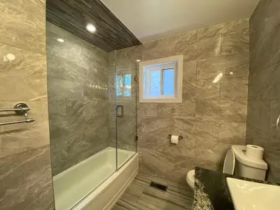 a bathroom with a shower and a tub and a sink at Yonge and Finch Subway !O Cozy & Modern Private Bdr with Private Half Bathroom in Toronto