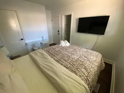 a bedroom with a bed and a flat screen tv at Yonge and Finch Subway !P Cozy & Quiet Private Bdr with Private Bathroom in Toronto