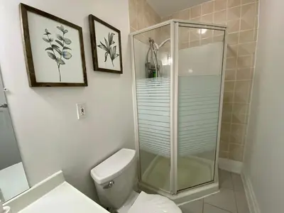 a bathroom with a toilet and a glass shower at Yorkmills and Bayview !B Spacious and Stylish Private Bdr with Shared Bathroom in Toronto