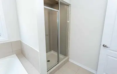 a shower with a glass door in a bathroom at The Warm Welcome Suite in Thorold